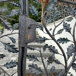 Detail of a forged gate with oak branches � designer fencing